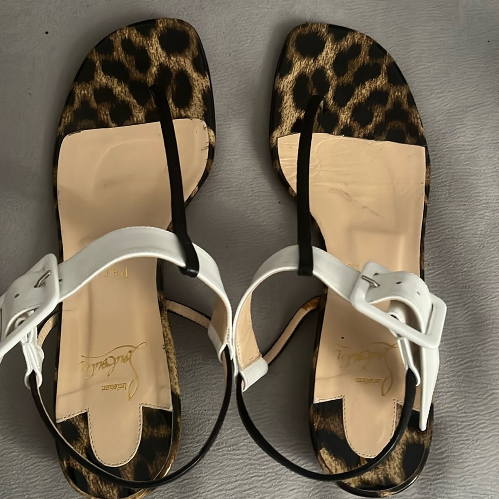 Loubotin gently used sandals black and white with leopard print around shoe